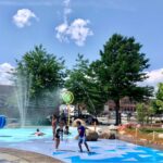 Photo of children enjoying the splash pad on a hot day