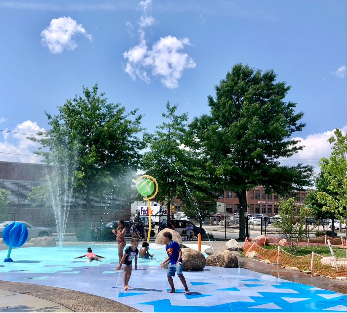 Photo of children enjoying the splash pad on a hot day