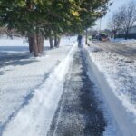 photo of a sidewalk that was shoveled after a snowstorm