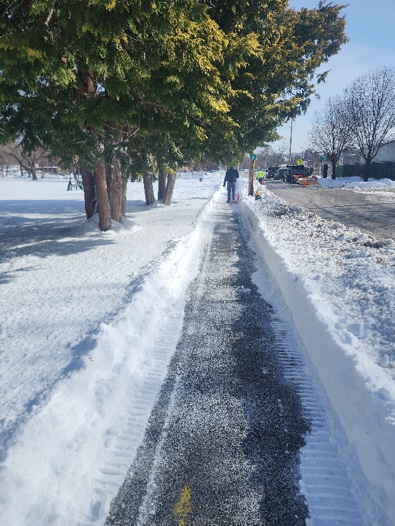 photo of a sidewalk that was shoveled after a snowstorm
