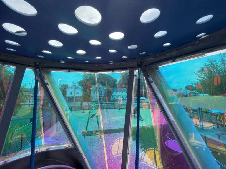 Neutaconkanut playground tower for ages 5-12 view of inside with perforated and colorful dichroic panel