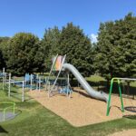Neutaconkanut play structure for ages 5-12 with tower and tunnel slide