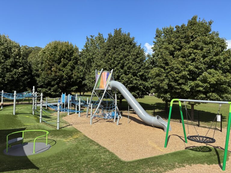 Neutaconkanut play structure for ages 5-12 with tower and tunnel slide