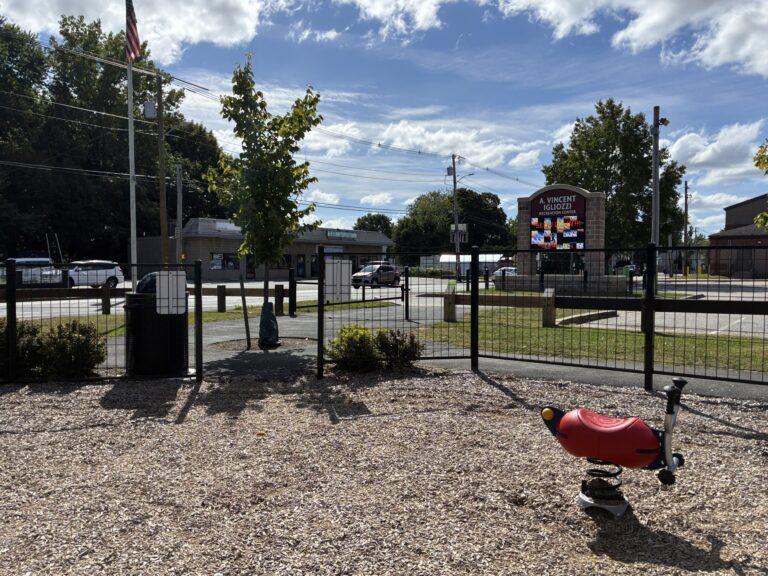 Neutaconkanut playground entrance at Plainfield St with spring rocker for ages 2-5