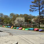 Father Lennon Park from the driveway entrance to Rogers Recreation center with colorful boulders and picnic area