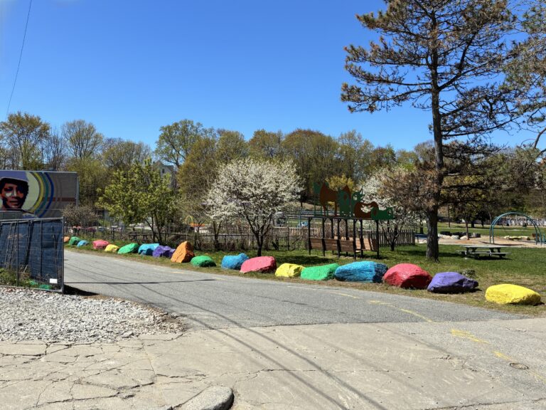 Father Lennon Park from the driveway entrance to Rogers Recreation center with colorful boulders and picnic area