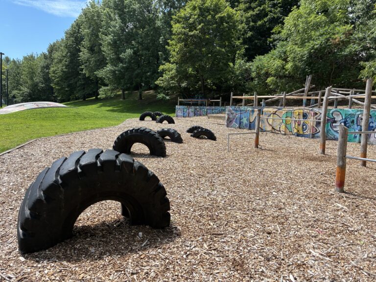 Father Lennon Park Parkour Area with Tires and Fitness Equipment and Skate bowl in the background