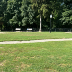 Franciscan Park central grass area with walking path with benches