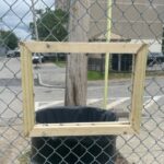Franciscan Park innovative chute in fence along Ridge St to deposit bagged dog waste