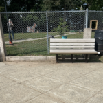 Franciscan Park features two benches on the outside of the park fence on Ridge St
