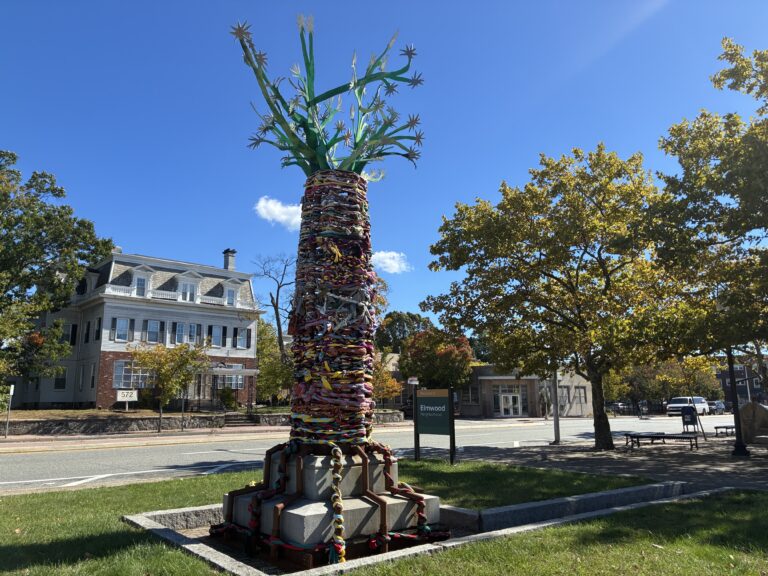 “The Storytelling AncesTree” sculptural installation at Columbus Square facing Elmwood Neighborhood sign