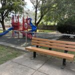 George Araujo Park bench outside of the playground area for ages 2-12