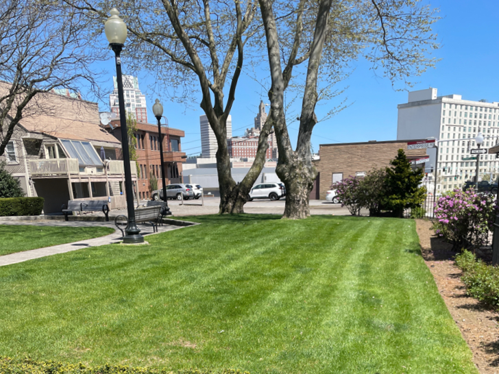 Garibaldi Square side lawn along Enterprise Row with Providence skyline in background