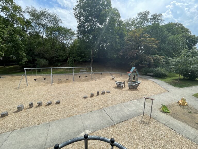 Gladys Potter Park view from play tower of the toddler play area and swings for ages 2-12