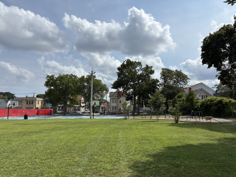 Harriet & Sayles Park open field with lush grass facing Oxford St
