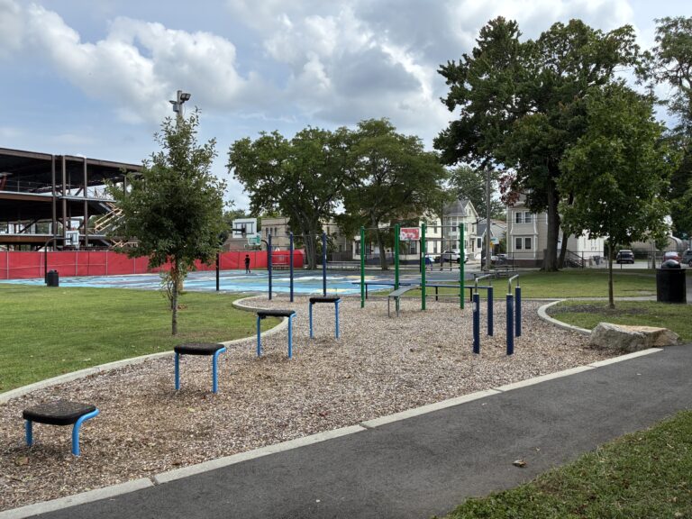 Harriet & Sayles Park fitness area for ages 13+ with basketball court in background