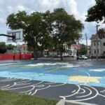 Harriet & Sayles Park basketball courts facing entrance on Oxford St
