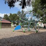 Harriet & Sayles Park play equipment for ages 2-5 with spherical climber and swings