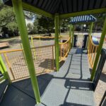 Hassett Park view from inside play structure with roof across bridge to curved slide