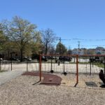 Hassett Park view of swings for ages 2-12 and basketball court from atop the play structure