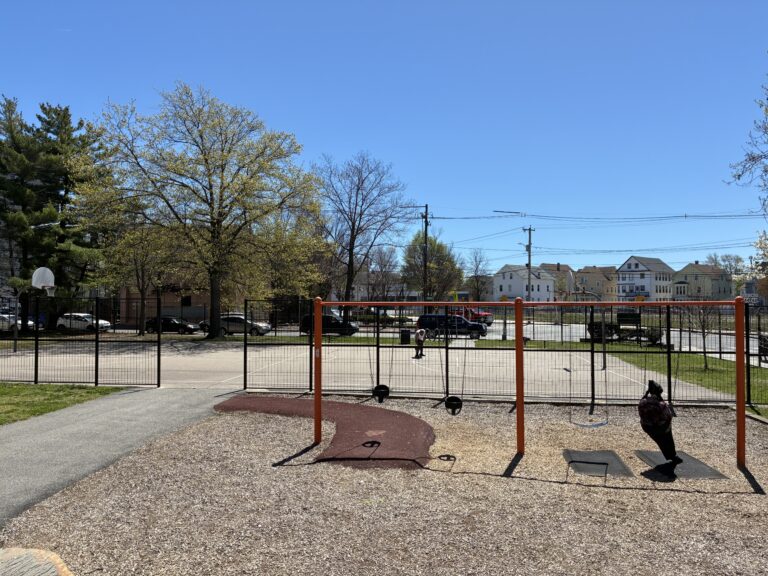 Hassett Park view of swings for ages 2-12 and basketball court from atop the play structure