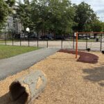 Hassett Park looking south to basketball court from playground crawl tube