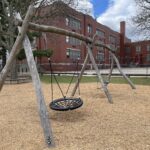 Iola French Park swings for ages 5-12 overlooking the elementary school