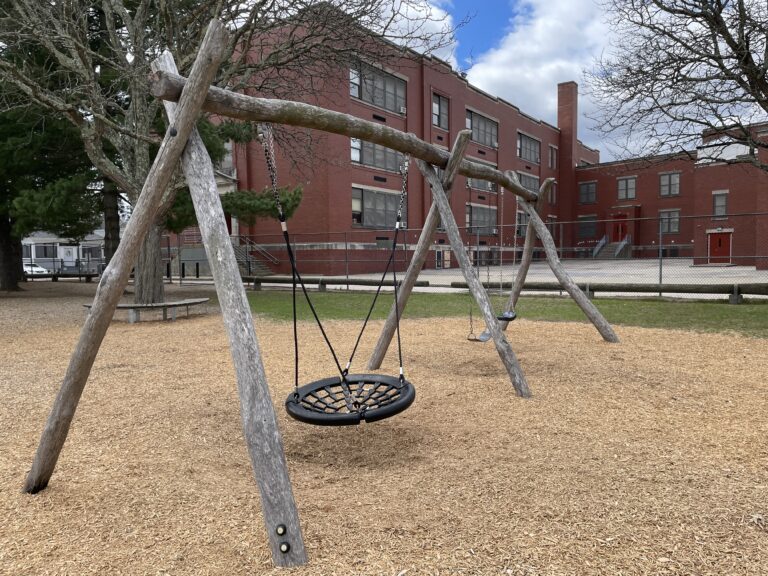Iola French Park swings for ages 5-12 overlooking the elementary school
