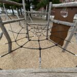 Iola French Park within the 6-sided climbing structure for ages 5-12 overlooking the spider web style cargo net
