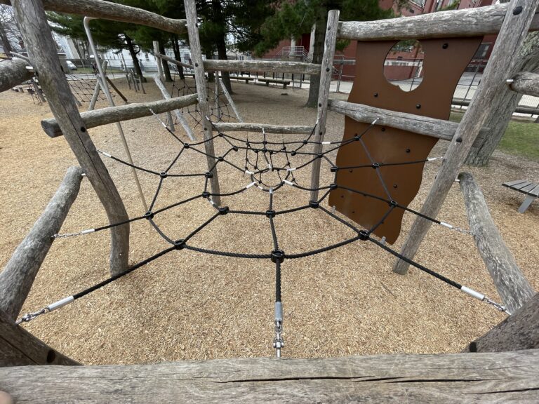 Iola French Park within the 6-sided climbing structure for ages 5-12 overlooking the spider web style cargo net