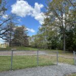 Iola French Park site of former playground features picnic area and seating, mature trees and walking path