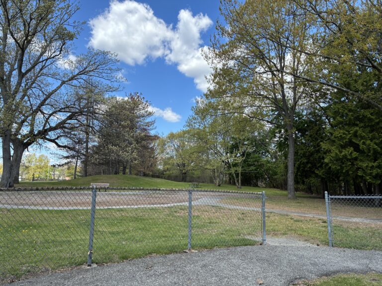 Iola French Park site of former playground features picnic area and seating, mature trees and walking path