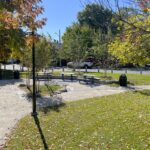 Jacqueline Clements Park picnic area looking southeast from the northwest corner of the park. Park features stone dust pathways throughout