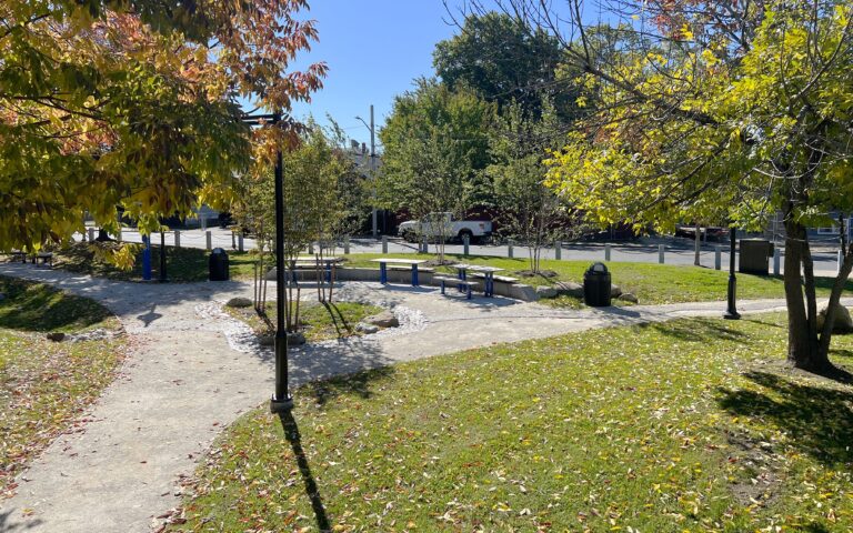 Jacqueline Clements Park picnic area looking southeast from the northwest corner of the park. Park features stone dust pathways throughout