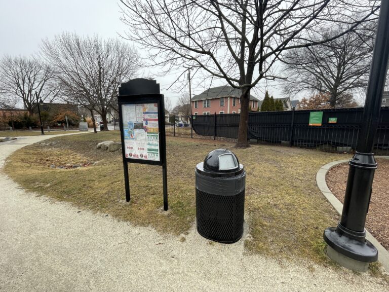 Jacqueline Clements Park community bulletin board with bioretention area in the background