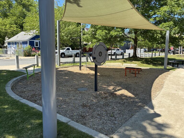 Jacqueline Clements Park fitness area features leg lift/pull up station, twist and flex wheel, and steps