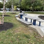 Jacqueline Clements Park picnic area features a seating wall and three tables including one ADA-accessible table