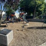 Jennifer Rivera Park from inside the park entrance viewing the memorial and various playground equipment