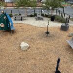 Jennifer Rivera Park view of playground spaceship themed climber for ages 2-5, and various park amenities from atop the play structure for ages 5-12
