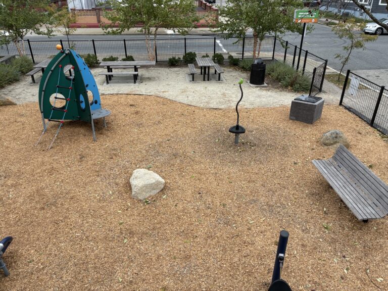 Jennifer Rivera Park view of playground spaceship themed climber for ages 2-5, and various park amenities from atop the play structure for ages 5-12
