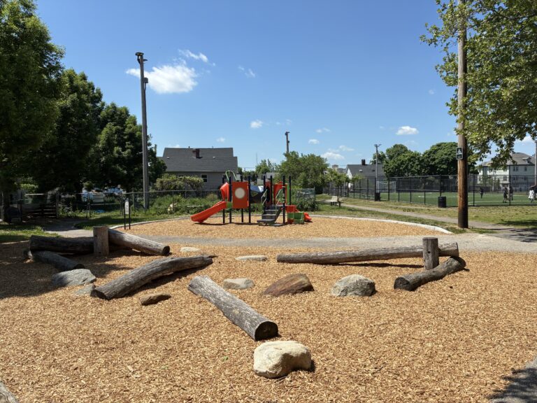 Joslin Park playground features natural play areas made of logs and boulders in addition to conventional metal and plastic composite play structures