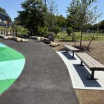 Joslin Park perimeter seating on the walking path around the splash pad