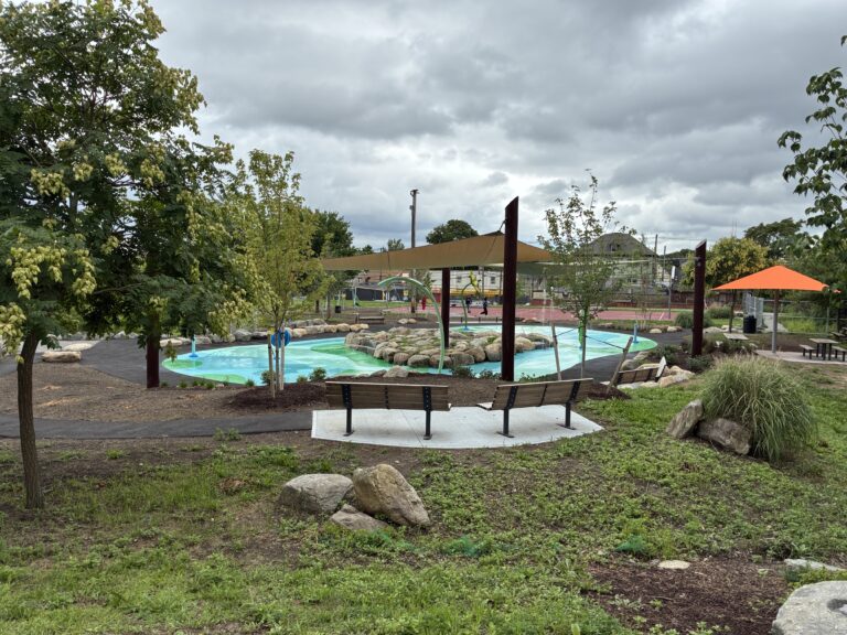 Joslin Park overlooking the splashpad from D'Abate school with a terraced seating area in the foreground