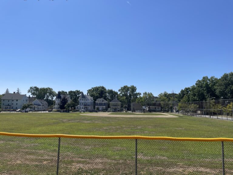 Joe Williams Field the baseball diamond viewed from the playground behind left field fence