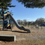 Joe Williams playground features a seat wall along the path around the play area