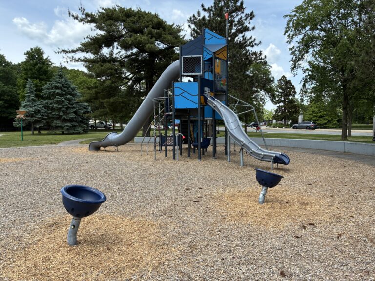 Joe Williams playground equipment includes spinner bowls and two large slides for ages 5-12