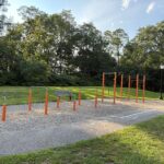 Joe Williams fitness area for ages 13 and up, located along the walking path with grass behind it