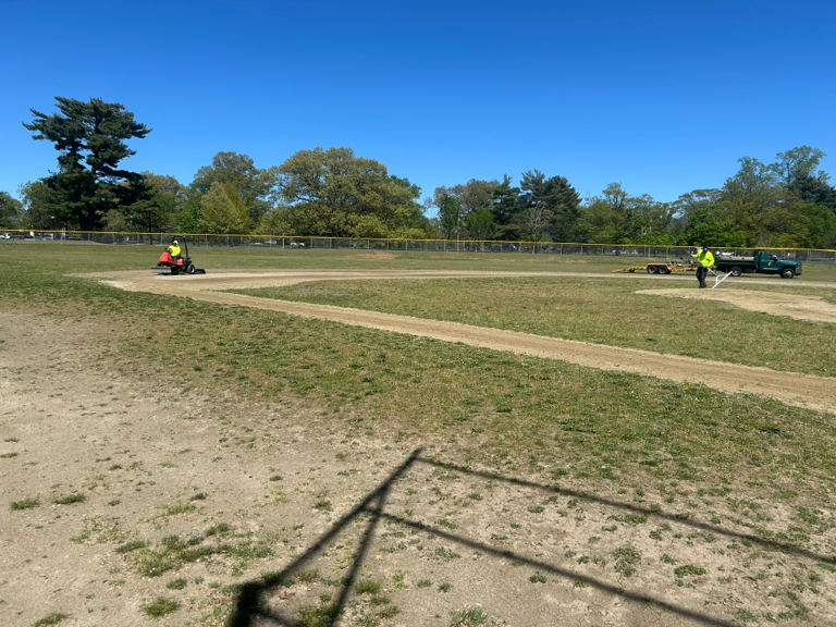 Joe Williams Field parks crew grooming the infield and pitcher's mound