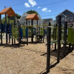 Mattie Smith Park play structure for ages 5-12 features pull up bars a fire pole and a track ride