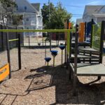 Mattie Smith Park play structure for ages 2-5 features a pod climber, steering wheel panel, and slide